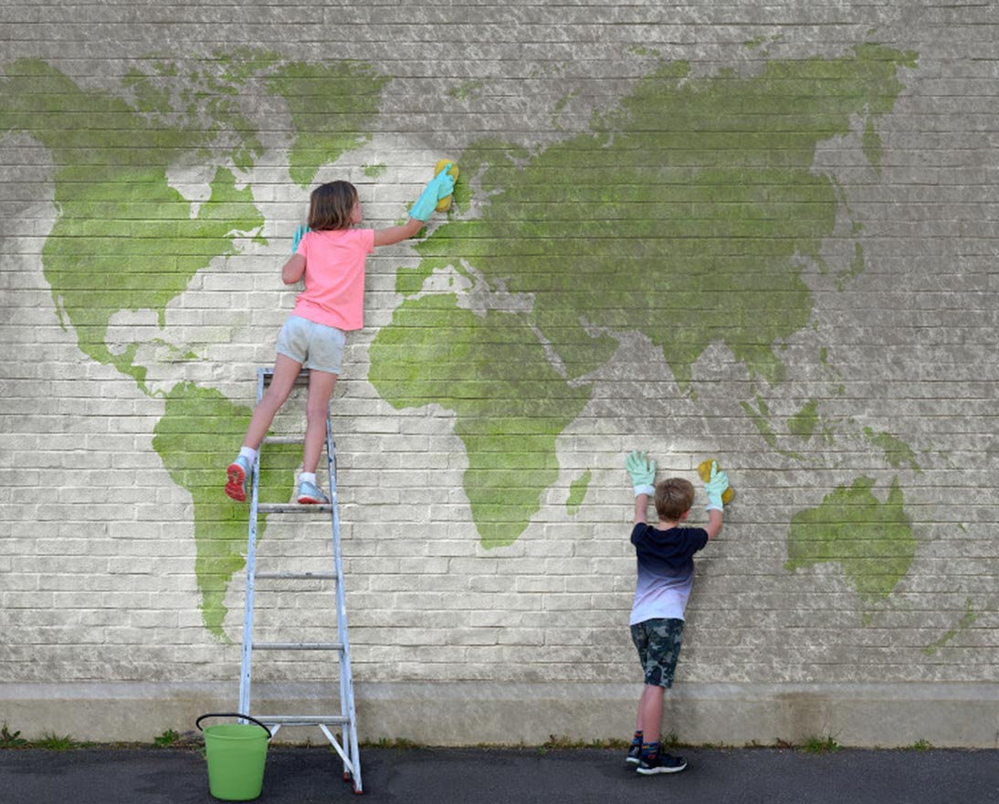 kids cleaning a wall with world map