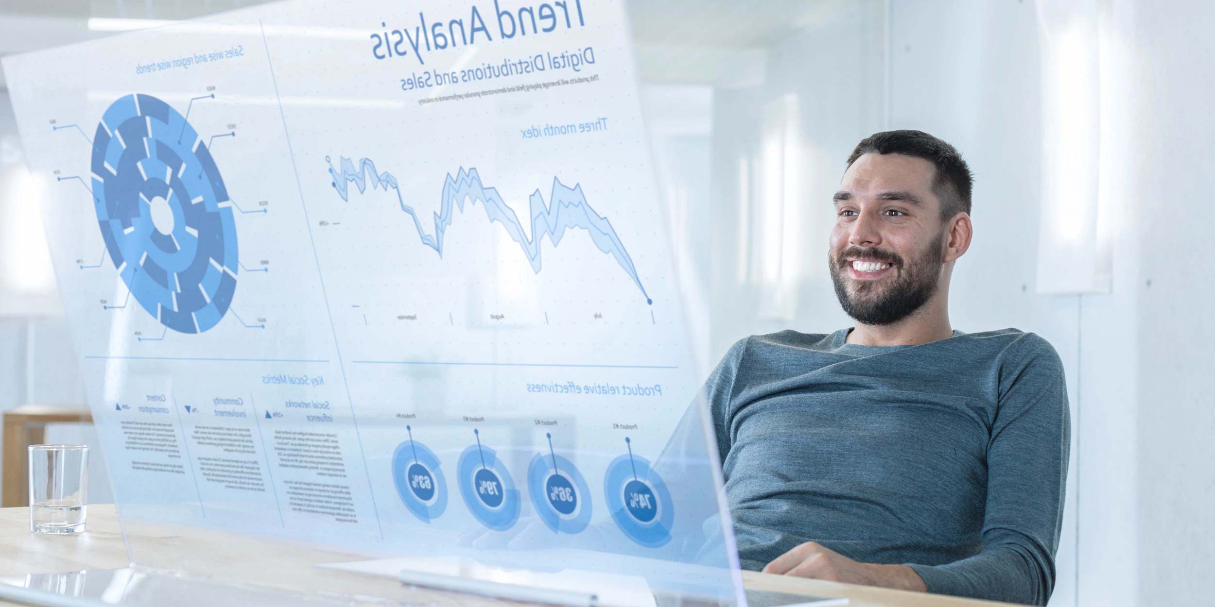 man smiling and looking at graphs