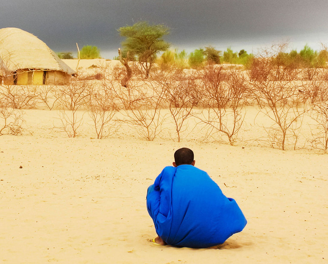 man sitting in desert
