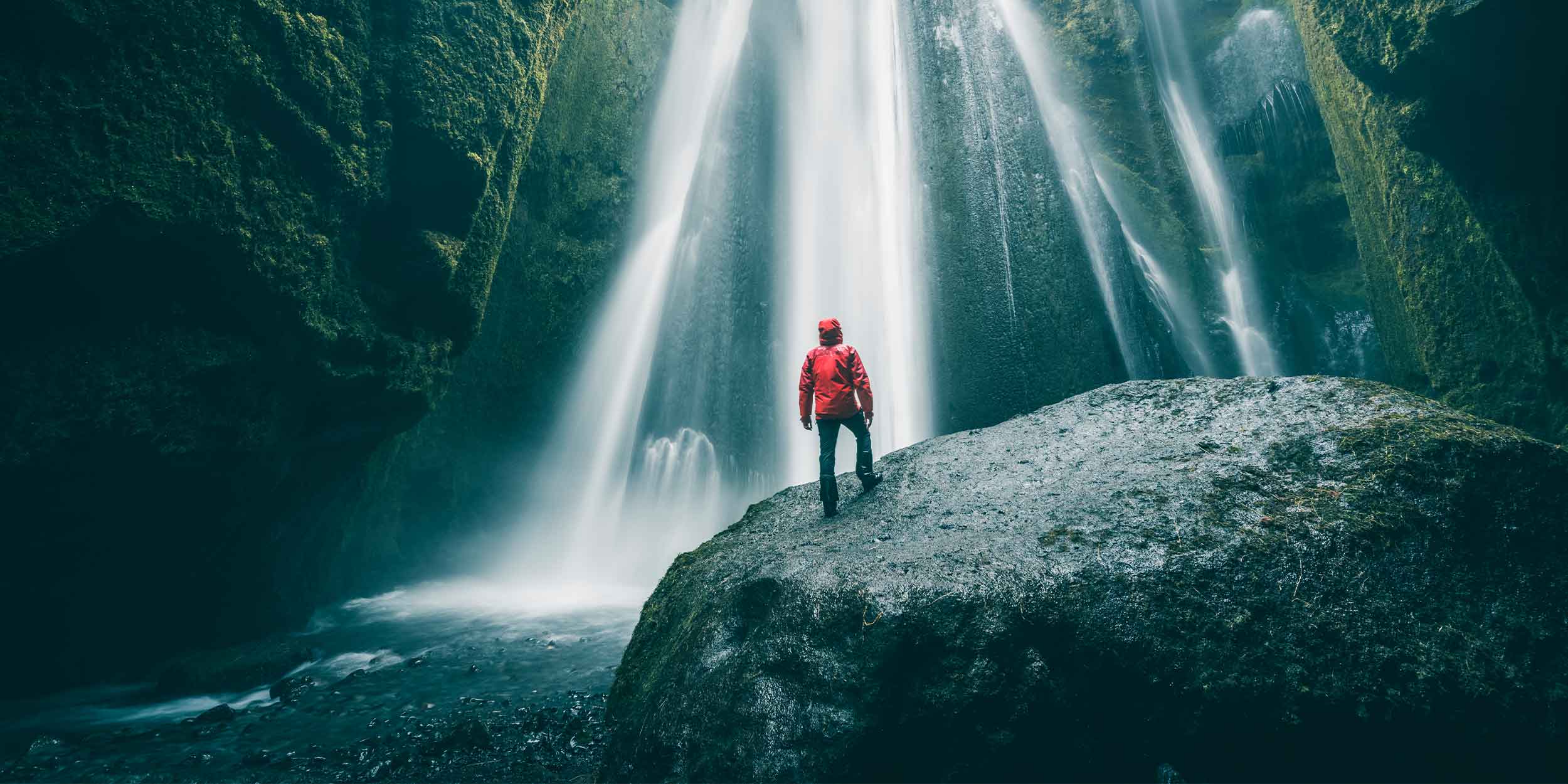 a person looking at a waterfall