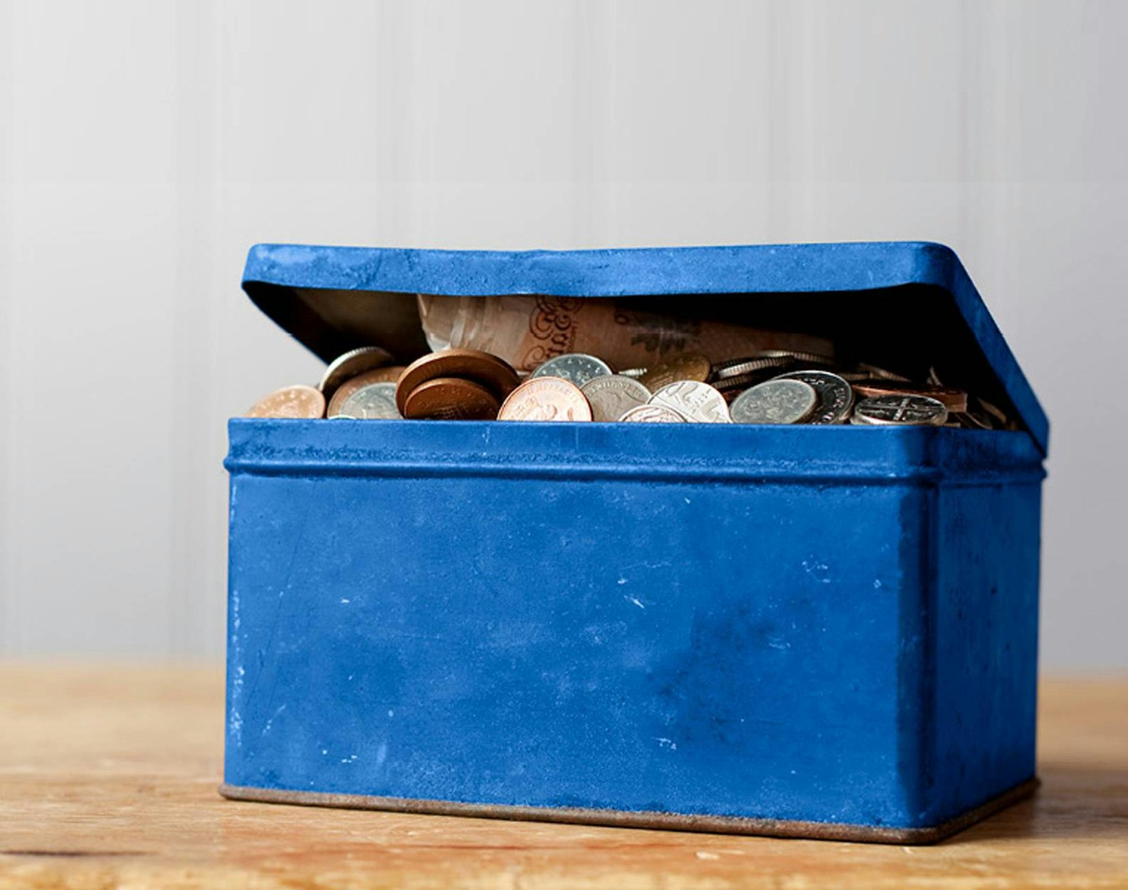 Blue tin with coins