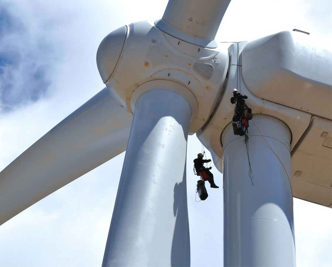Workers on a wind turbine creating renewable energy